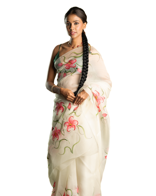 Woman wearing a pink floral sheer saree on a white background