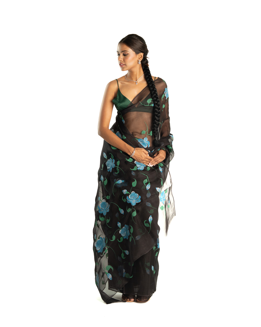 Woman wearing a black floral saree on a white background