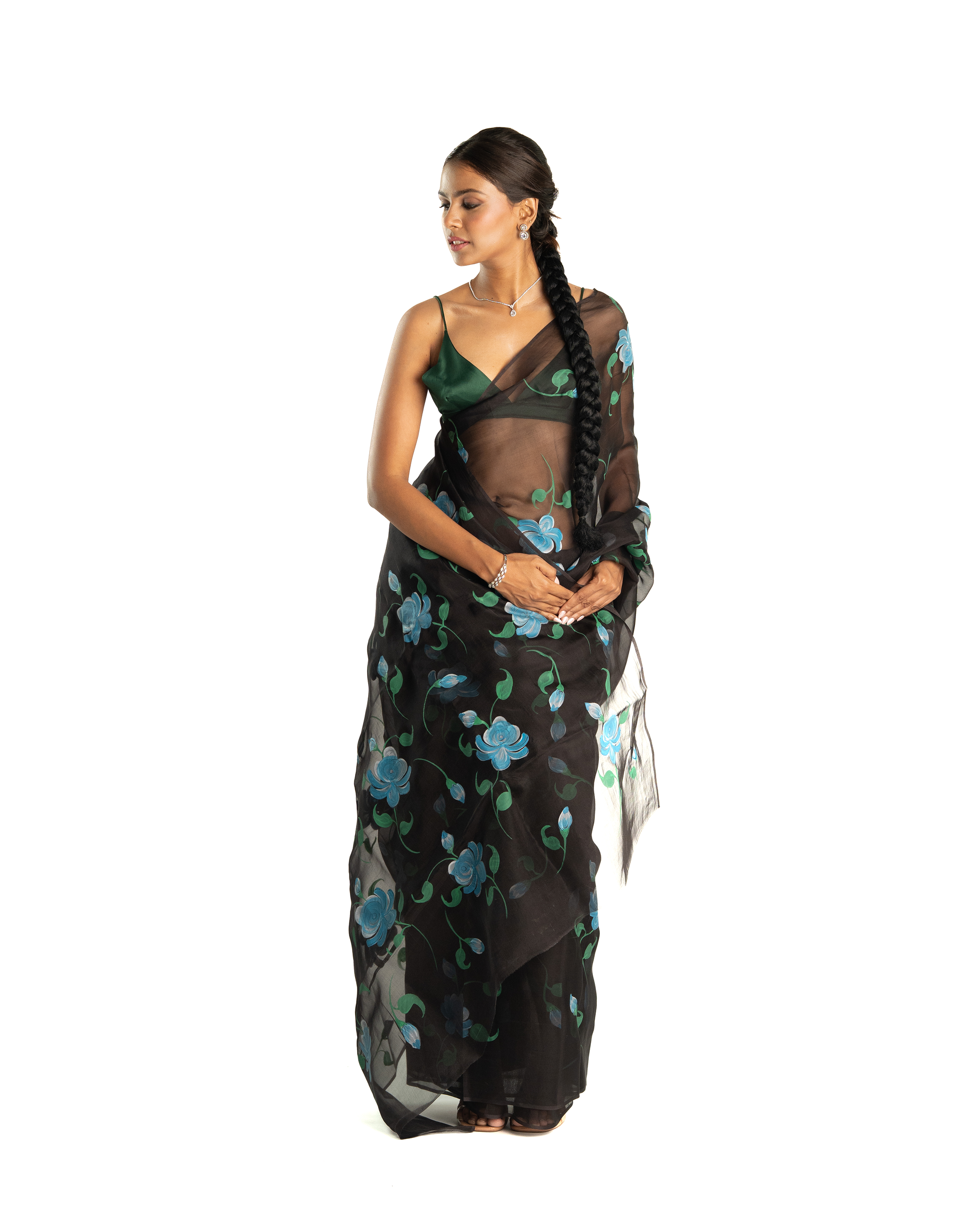 Woman wearing a black floral saree on a white background