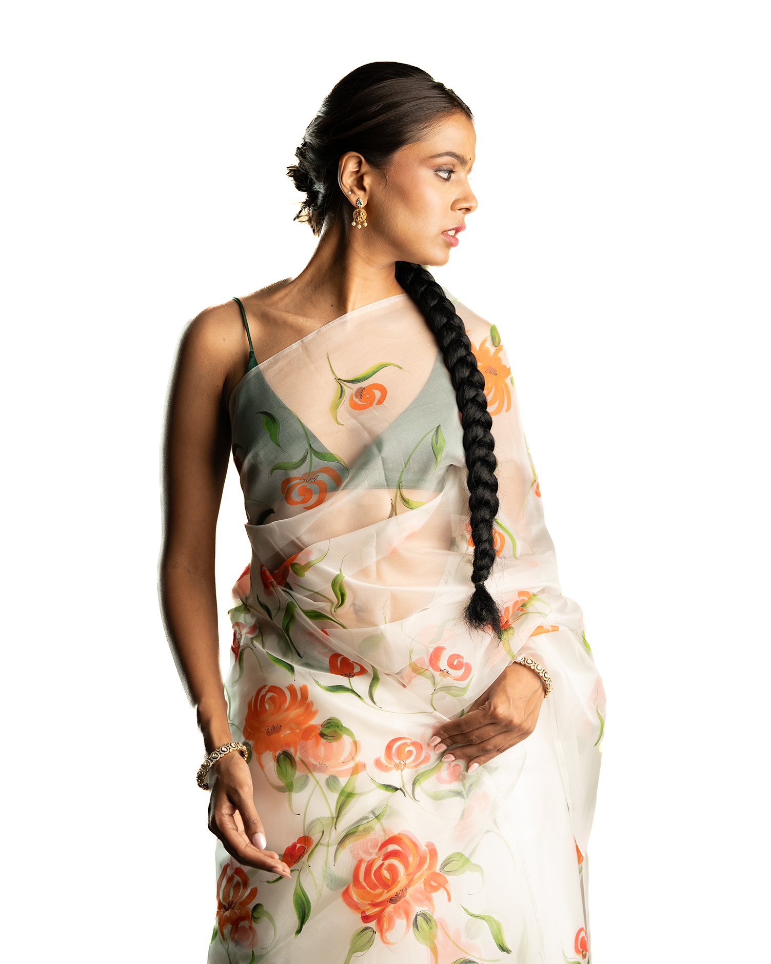 Woman wearing a orange floral sheer saree on a white background
