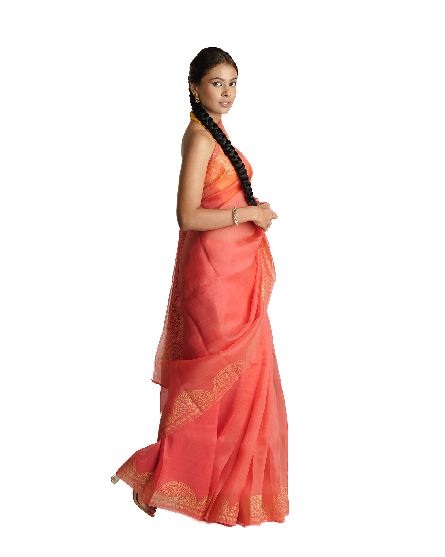 Woman wearing a coral saree with a white background