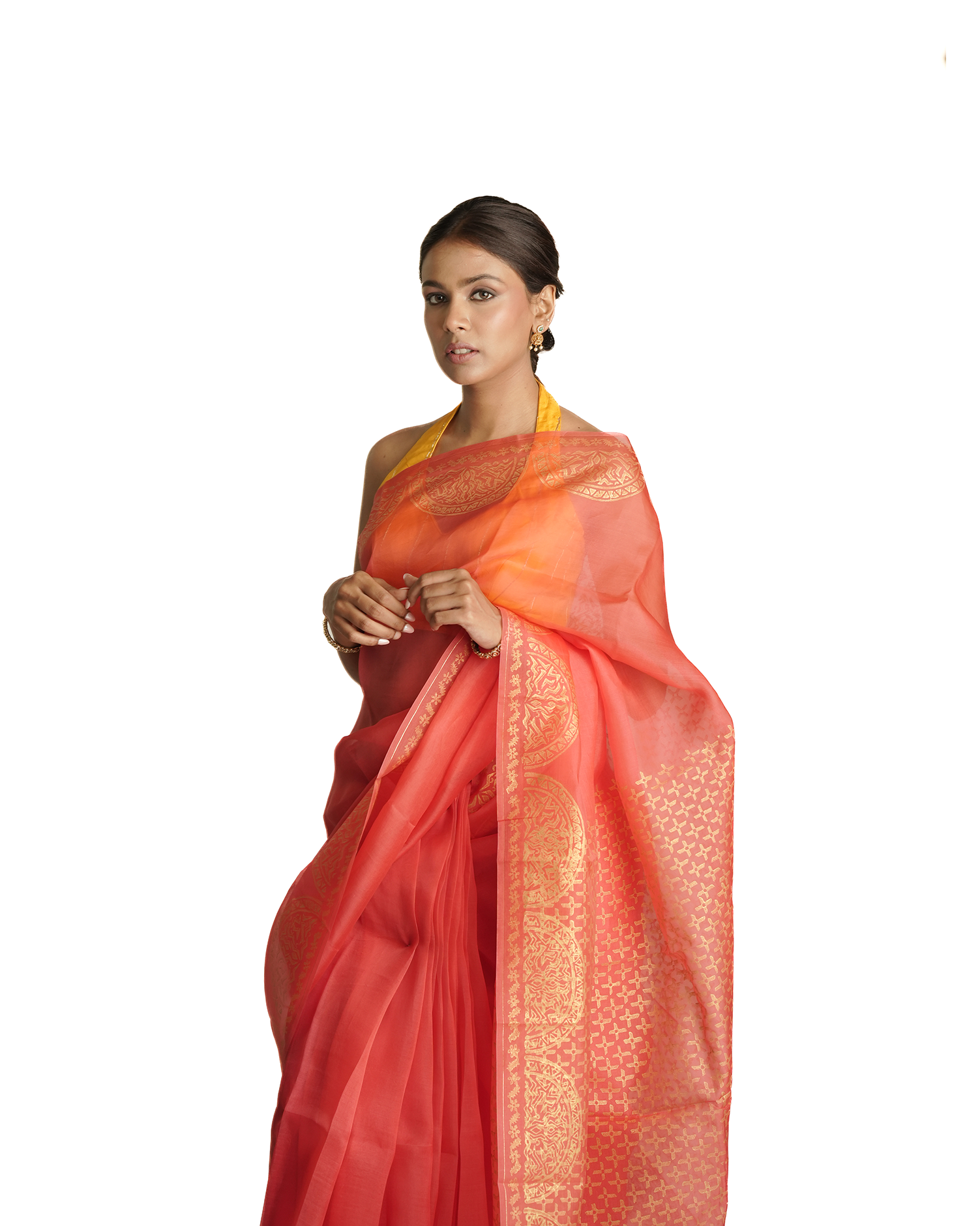 Woman wearing a red and orange saree with a white background