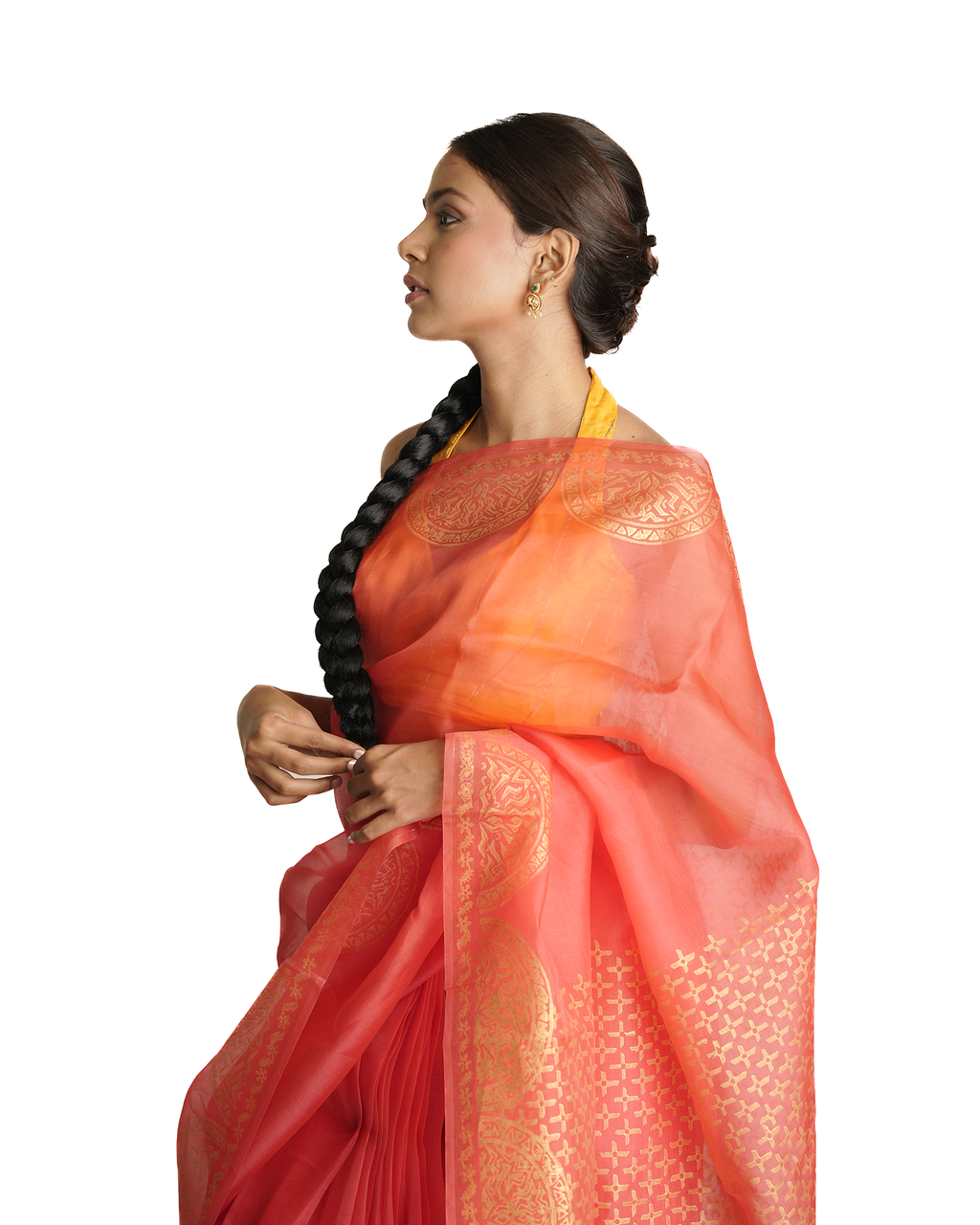Woman wearing a vibrant orange and red saree with a white background