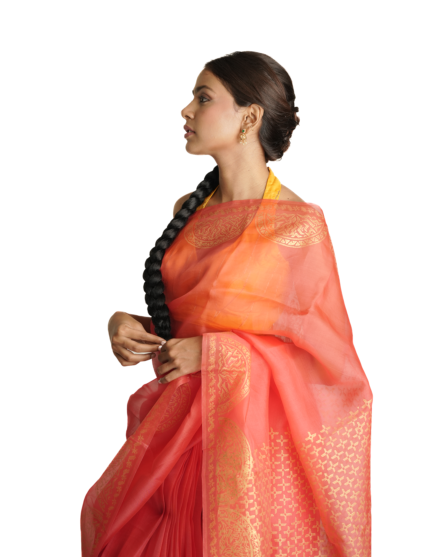 Woman wearing a vibrant orange and red saree with a white background