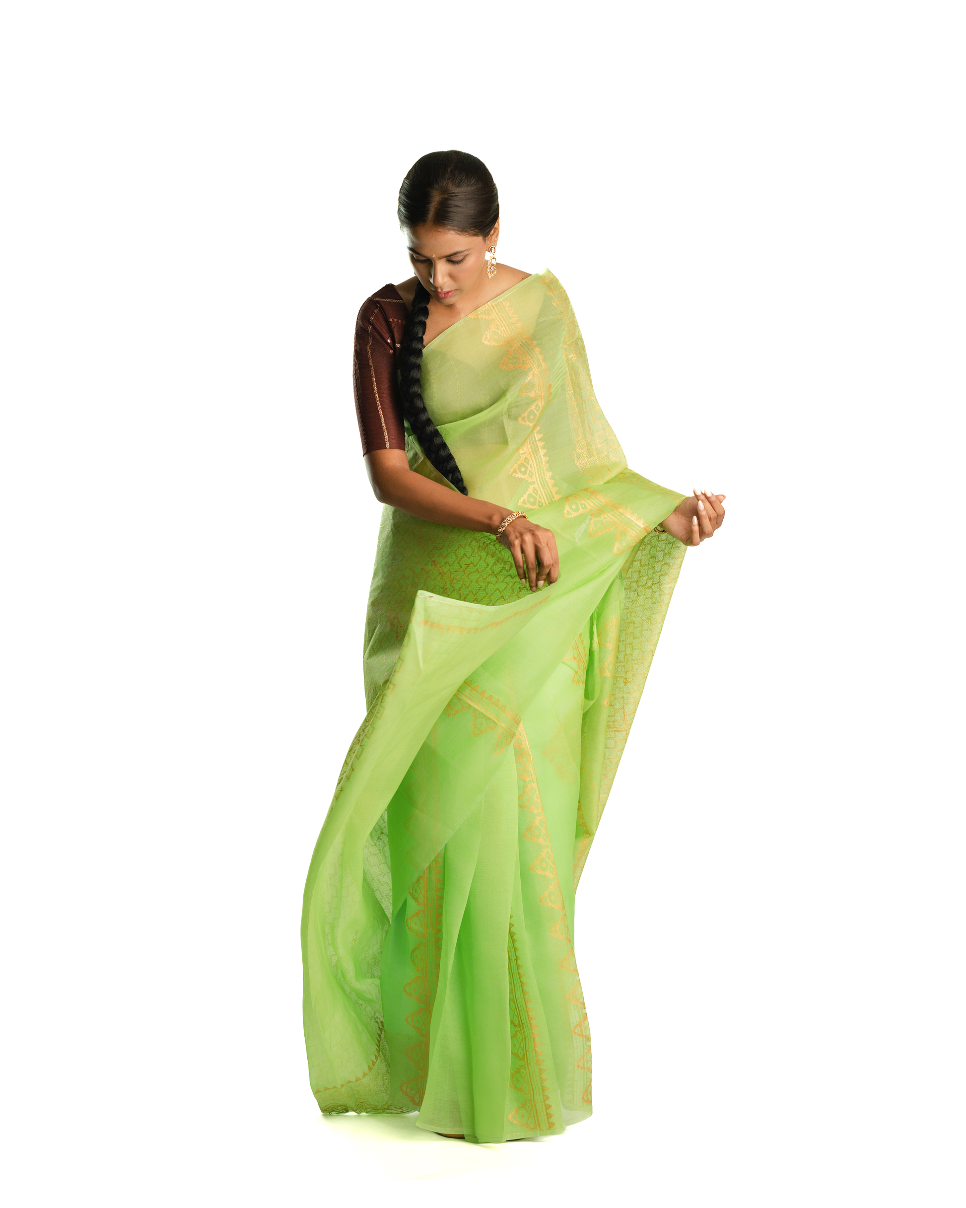Woman wearing a green handblock saree on a white background