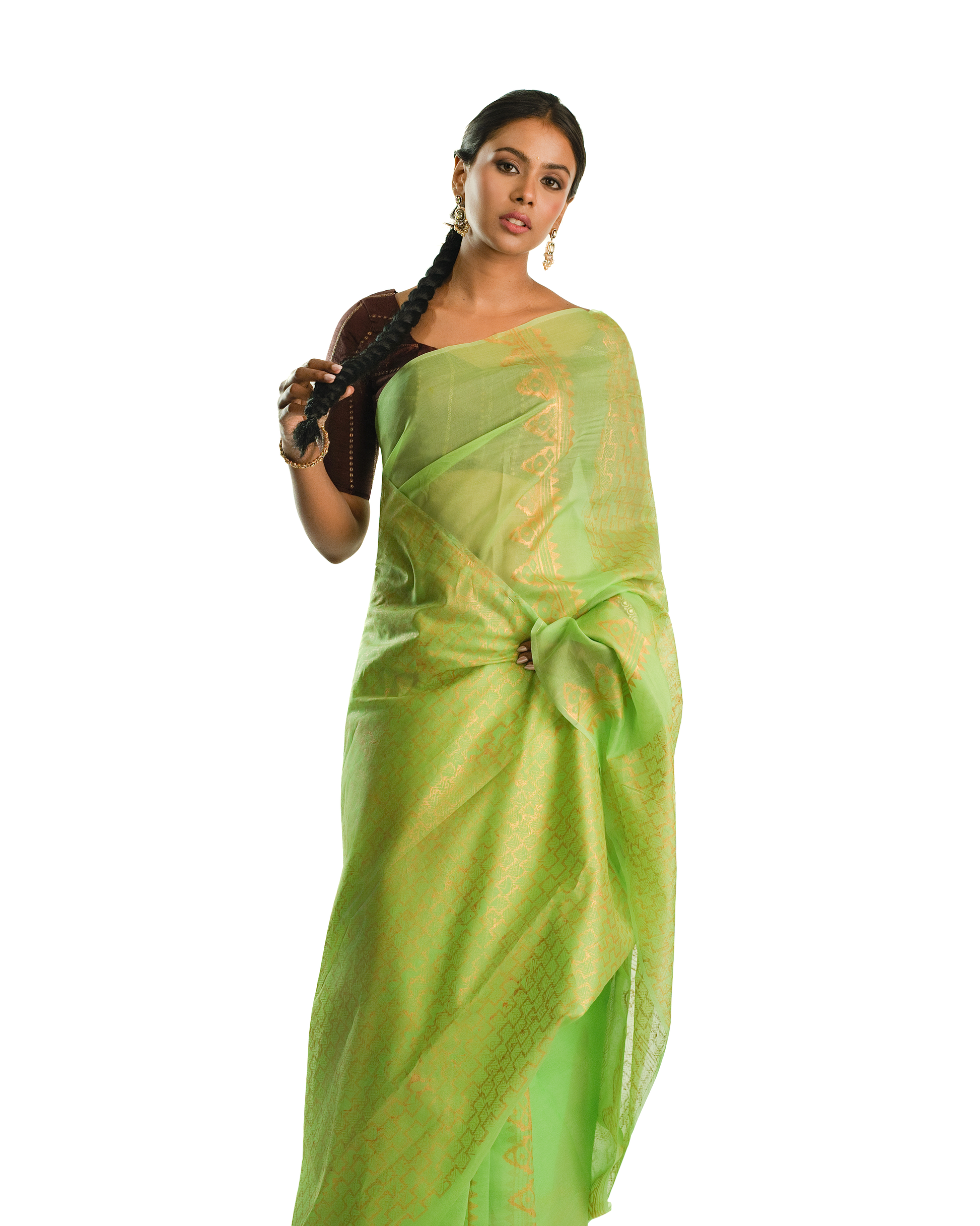 Woman wearing a light green saree with a white background