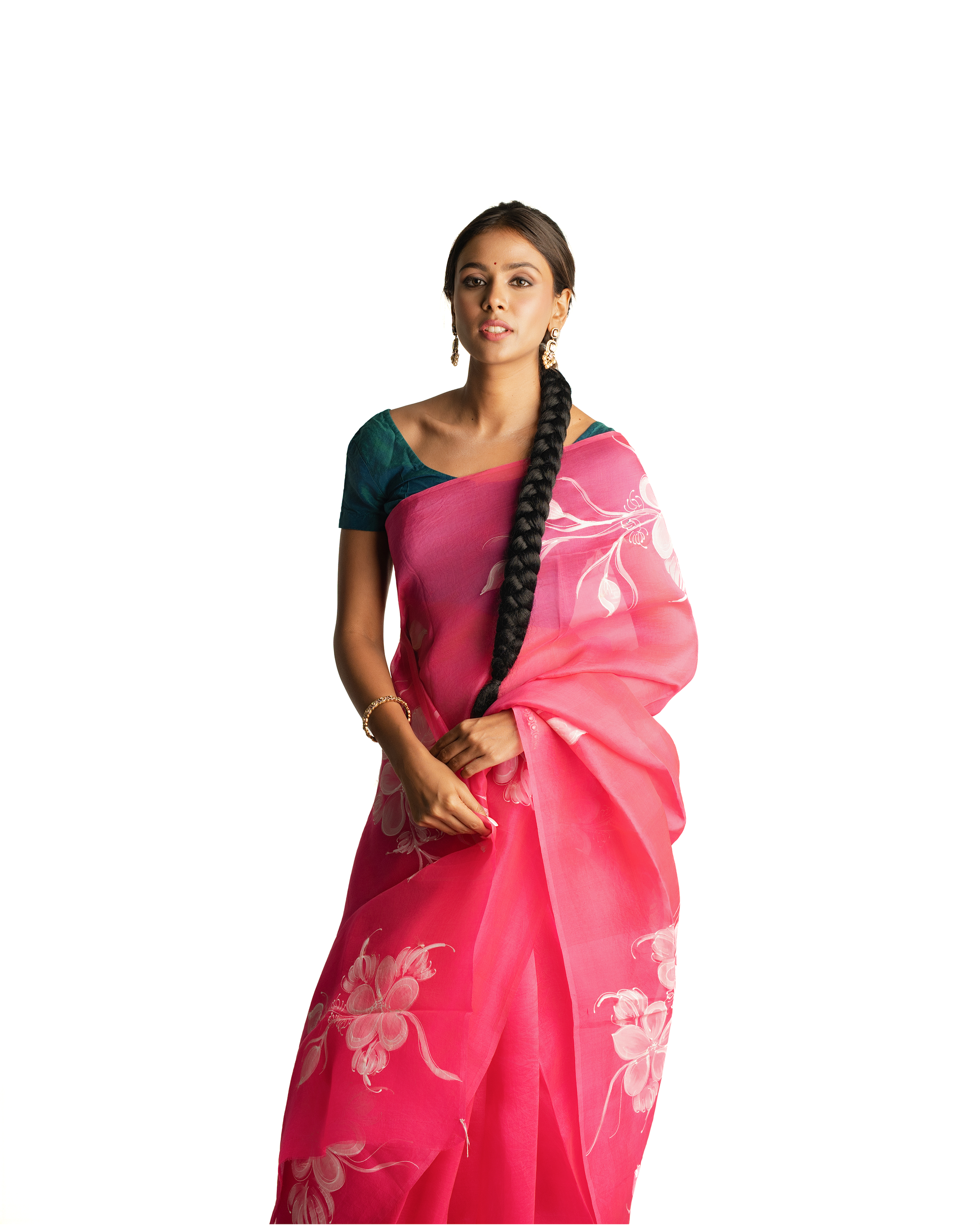 Woman wearing a pink saree with white floral patterns on a white background