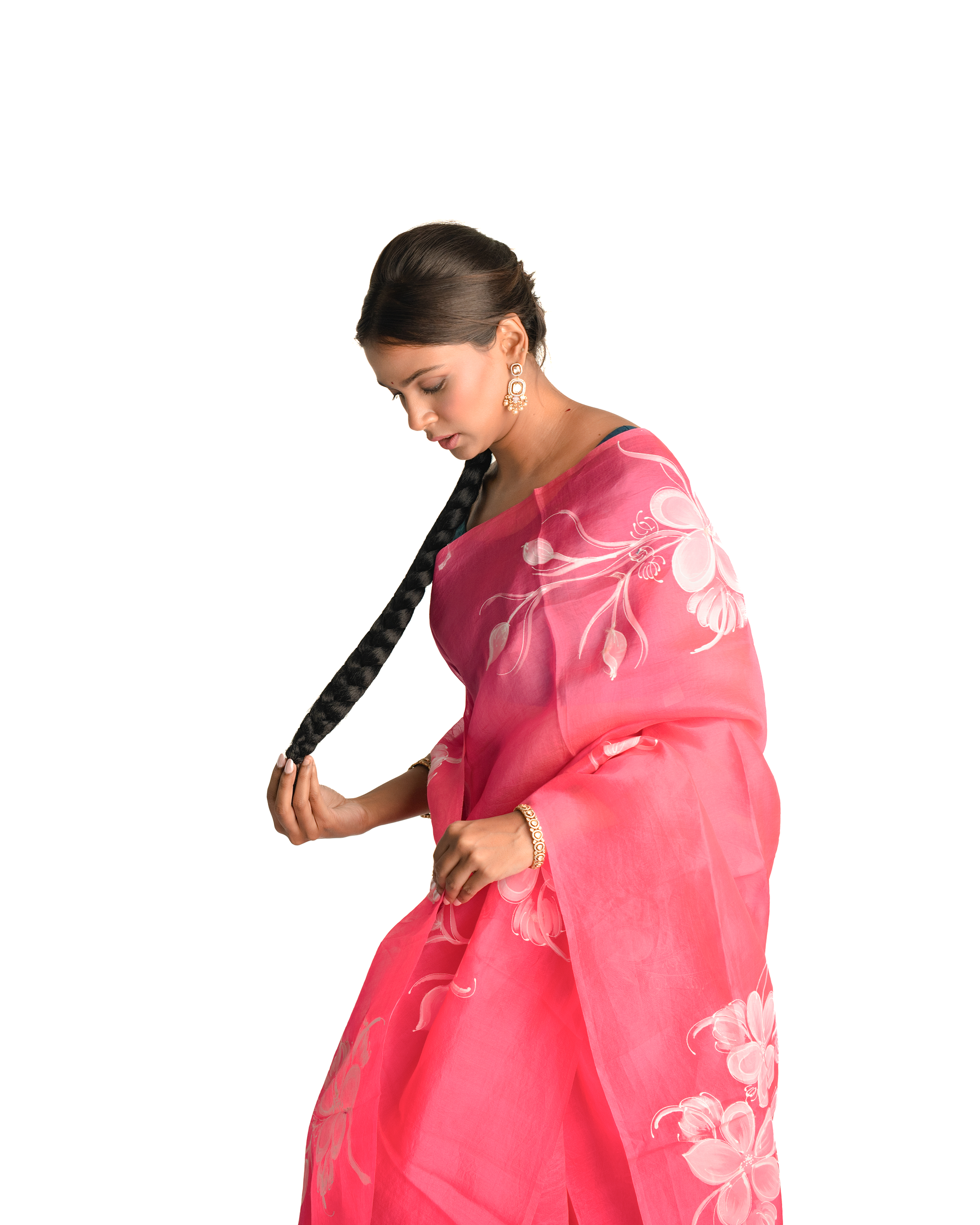 Woman wearing a pink saree with white floral patterns on a white background